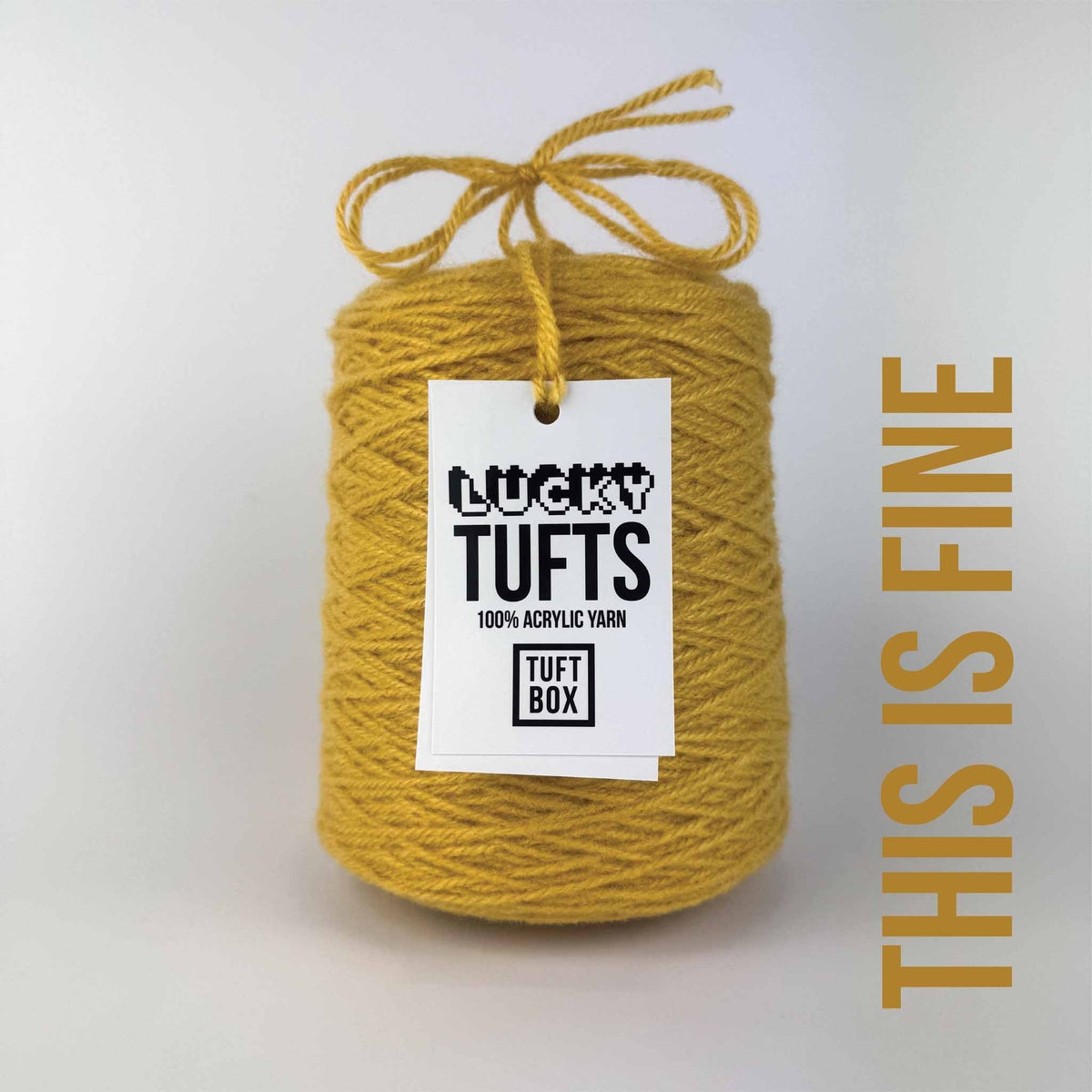 A cone of Lucky Tufts™ acrylic tufting and punch needle yarn in the colour This is Fine a dark muted yellow 