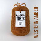 A cone of Lucky Tufts™ acrylic tufting and punch needle yarn in the colour Western Amber a dark brown orange 