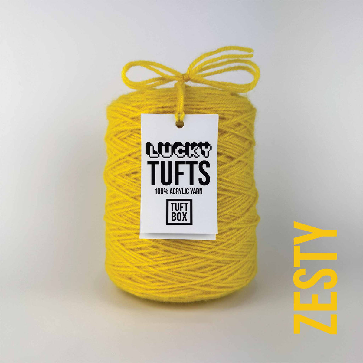 A cone of Lucky Tufts™ acrylic tufting and punch needle yarn in the colour Zesty. A warm yellow with a hint of orange.