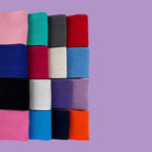 Stack of colourful folded webbing herringbone tapes on a purple background