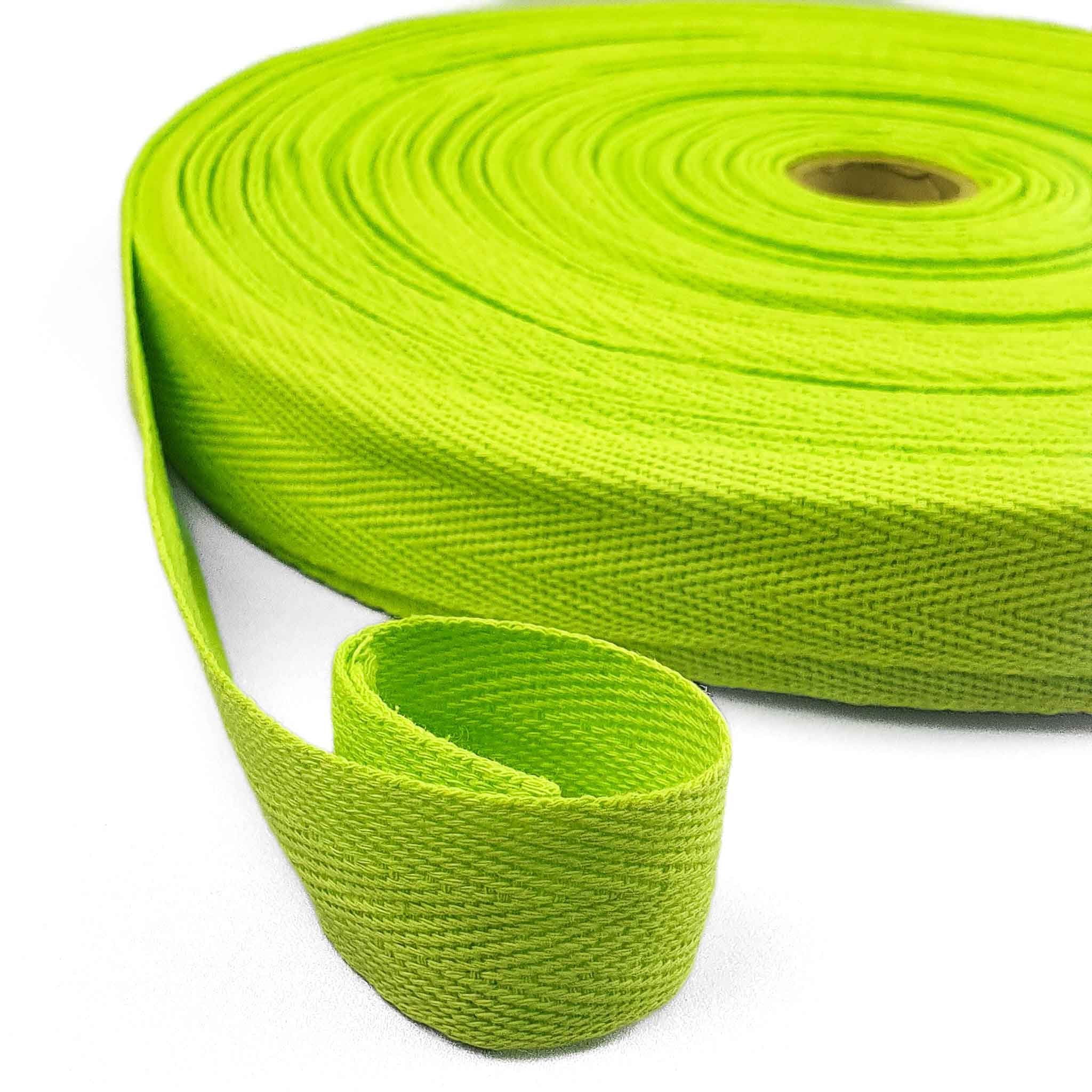 Green webbing twill tape roll on a white background