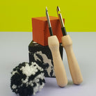Wooden Punch Needle Set of 2 on concrete blocks with pom pom 